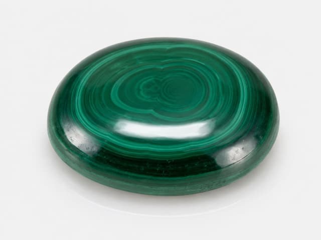 Banded green Malachite stone with natural transformation patterns.