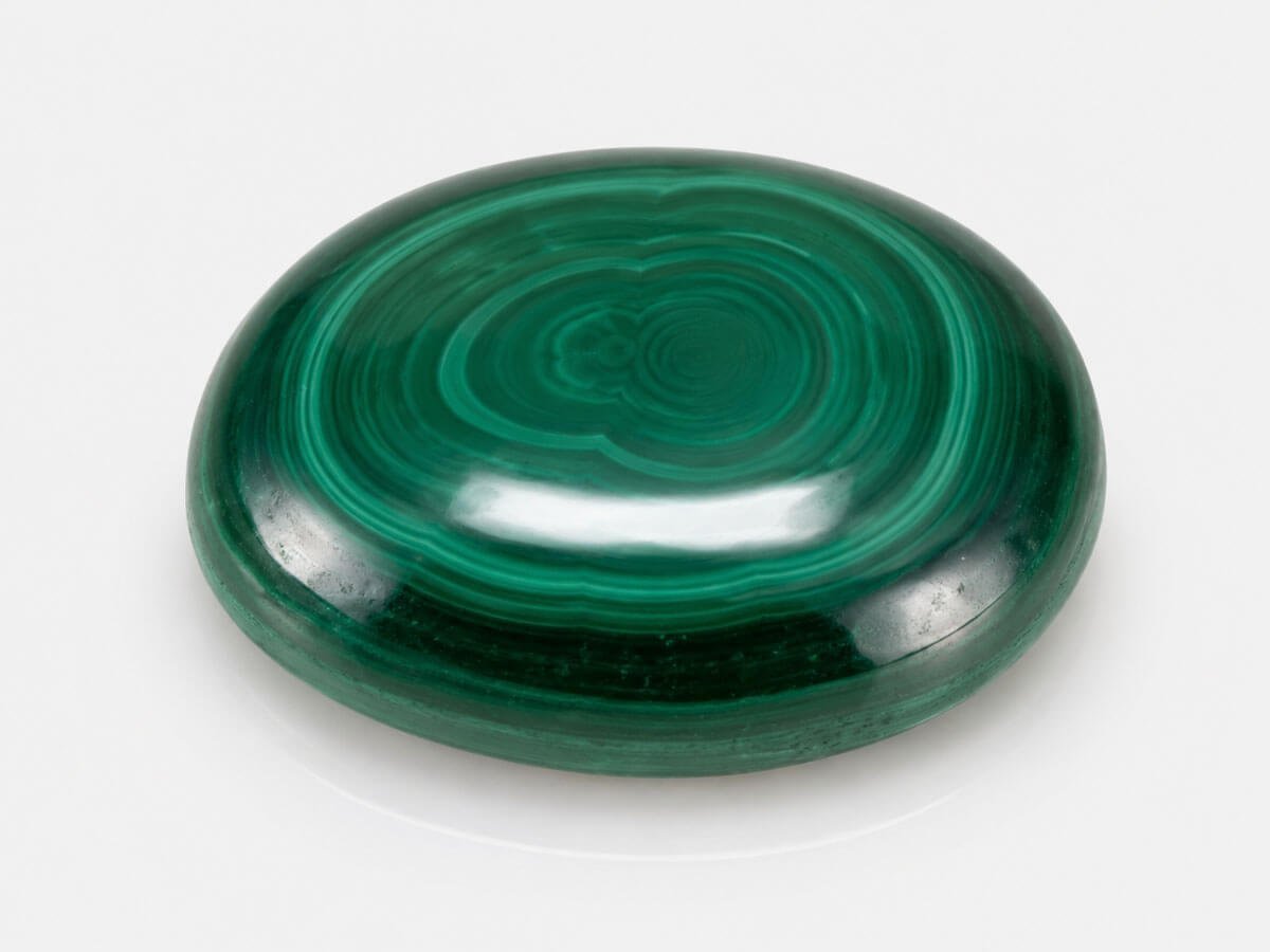 Banded green Malachite stone with natural transformation patterns.