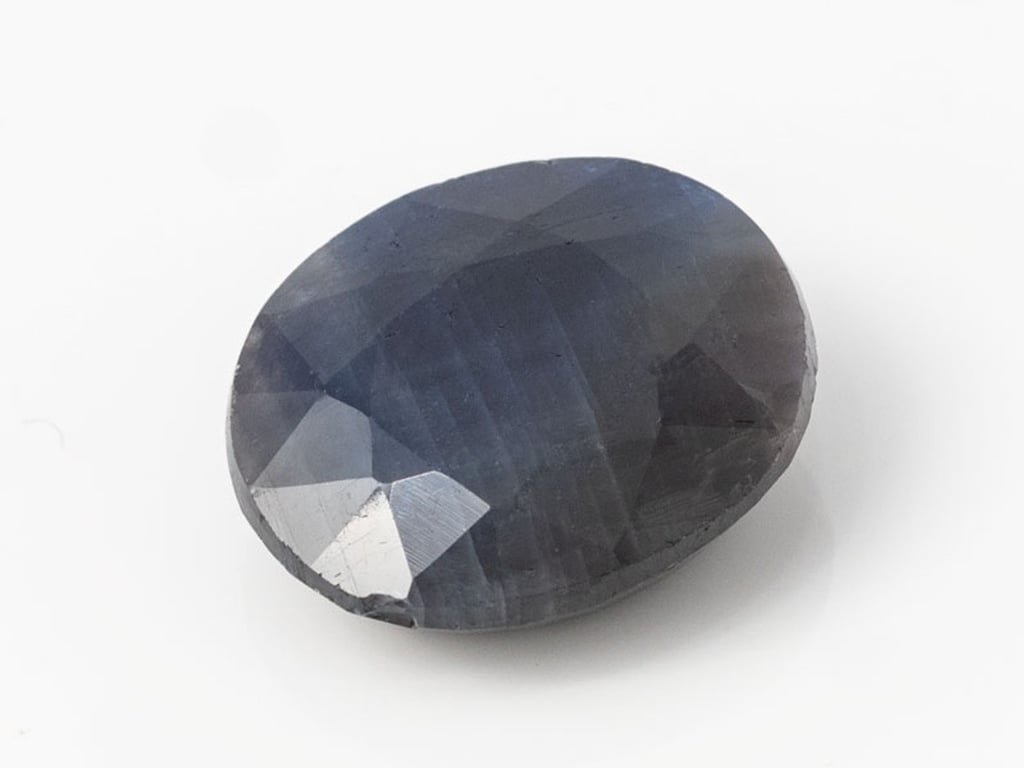 African Blue Sapphire Neelam 7.46 Carat top view, deep blue oval mix cut