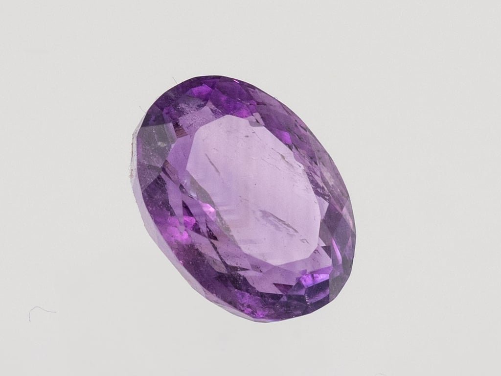 Natural Amethyst (Jamunia) 6.88 carat, top face-up view showing purple color and oval shape