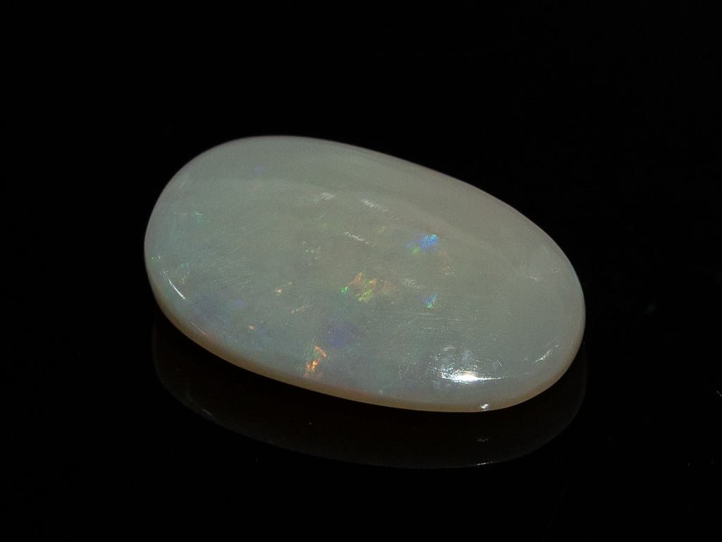 Natural Australian White Opal Stone 5.51 Carat top view: white body with soft blue, green and orange flashes