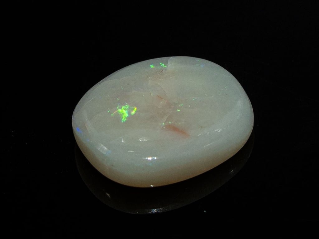 Natural Australian White Opal Stone 5.57 Carat top view: white body with green flashes and pinkish natural patches