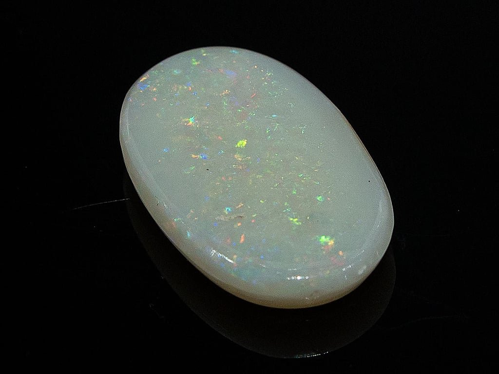 Natural Australian White Opal Stone 6.00 Carat top view: white body covered with multicoloured pinpoint flashes