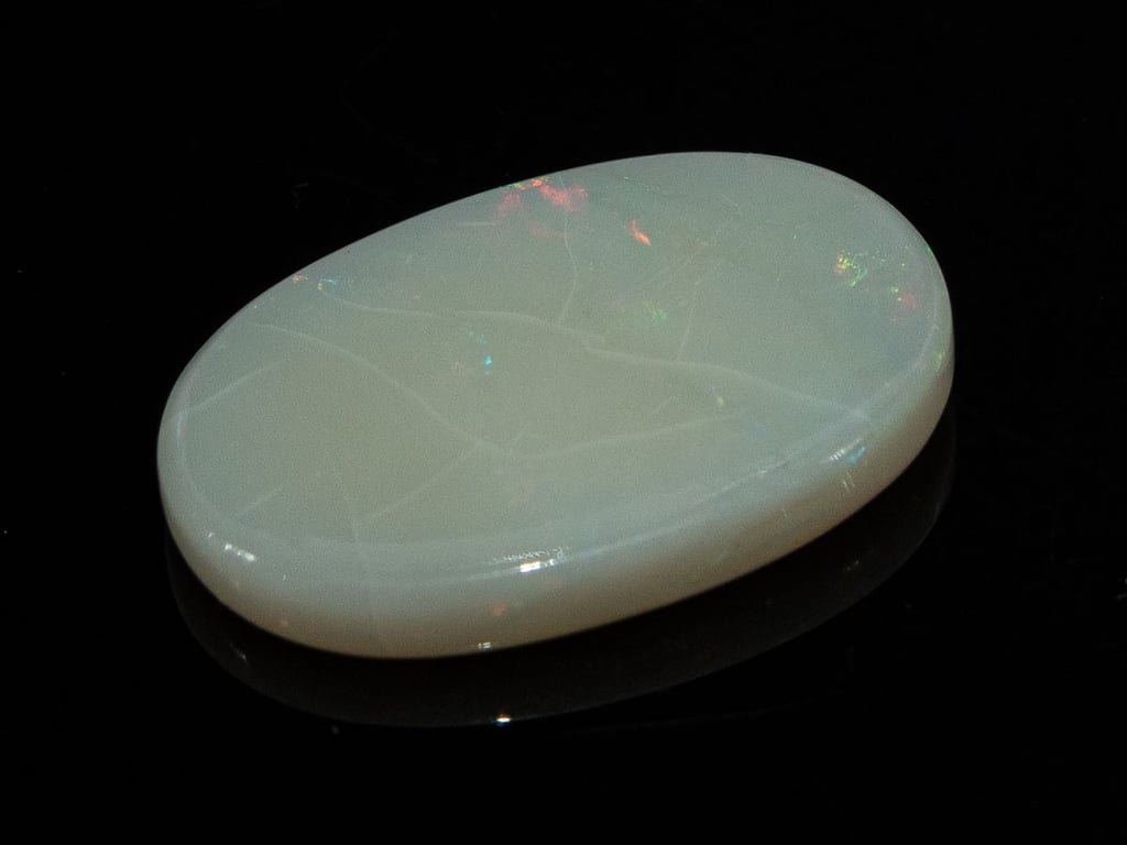 Natural Australian White Opal Stone 6.01 Carat top view: white body with small red-pink and green flashes