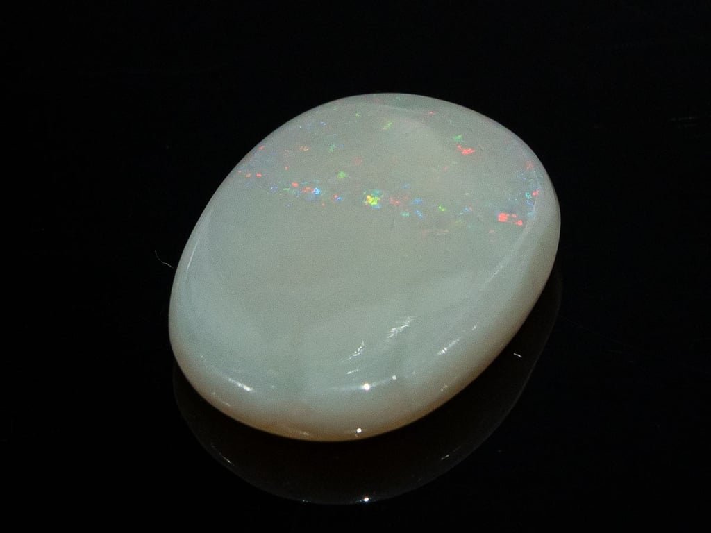 Natural Australian White Opal Stone 6.54 Carat top view: white body with a band of multicoloured pinpoint flashes