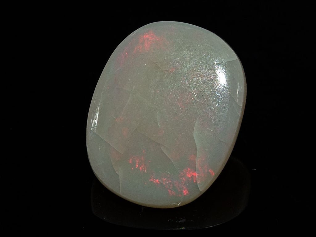 Natural Australian White Opal Stone 6.56 Carat top view: white body with red-pink flash patches