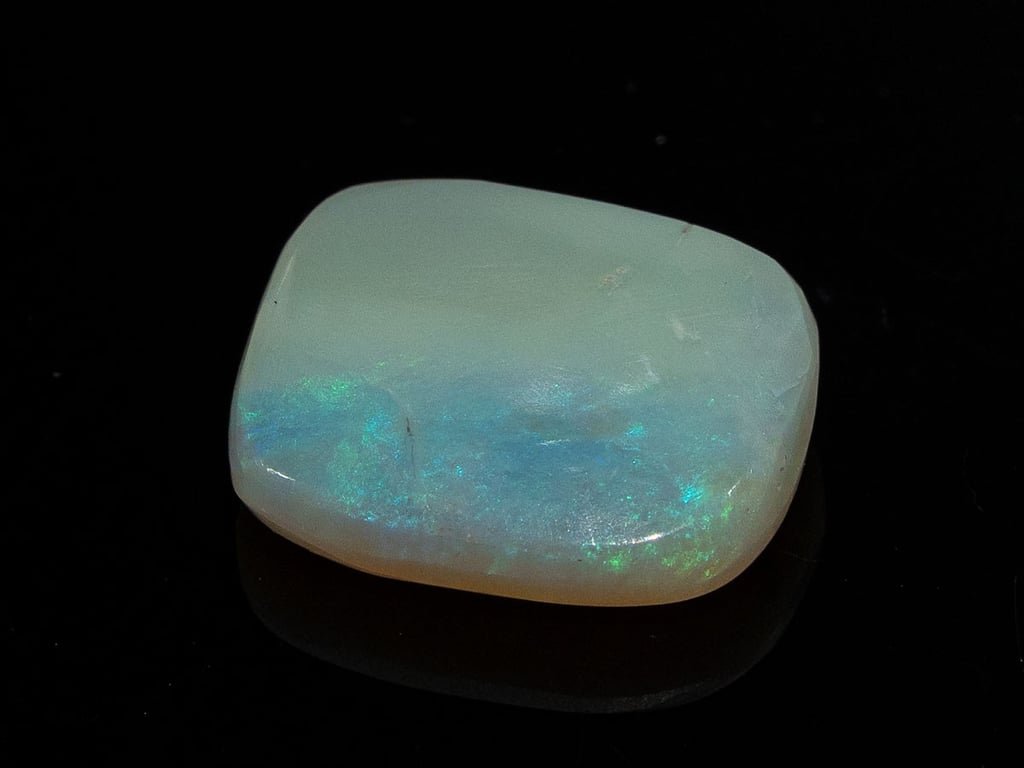 Natural Australian White Opal Stone 6.91 Carat top view: grey-white body with a broad band of blue-green colour