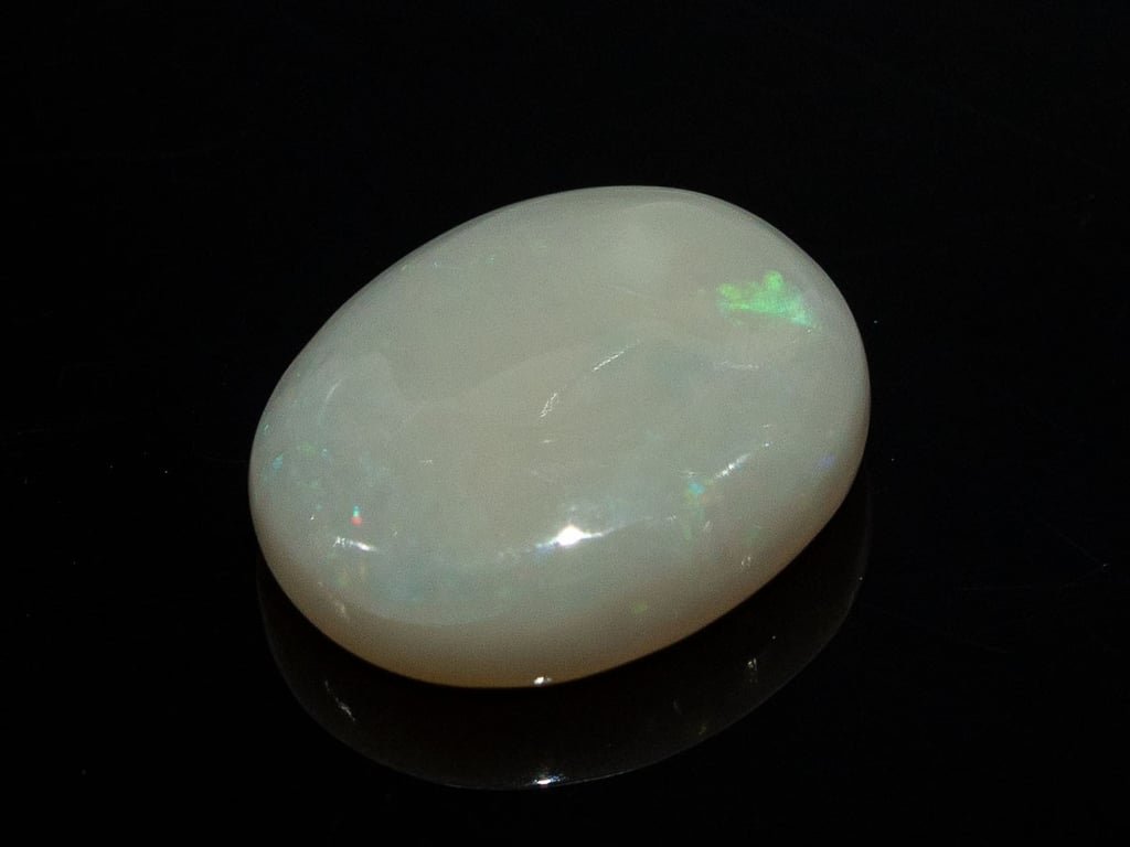 Natural Australian White Opal Stone 7.26 Carat top view: white body with a green flash and fine pinpoint flashes