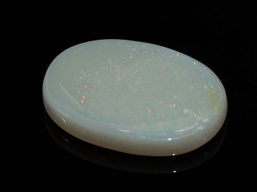 Natural Australian White Opal Stone 7.27 Carat top view: white body with small orange and green pinpoint flashes
