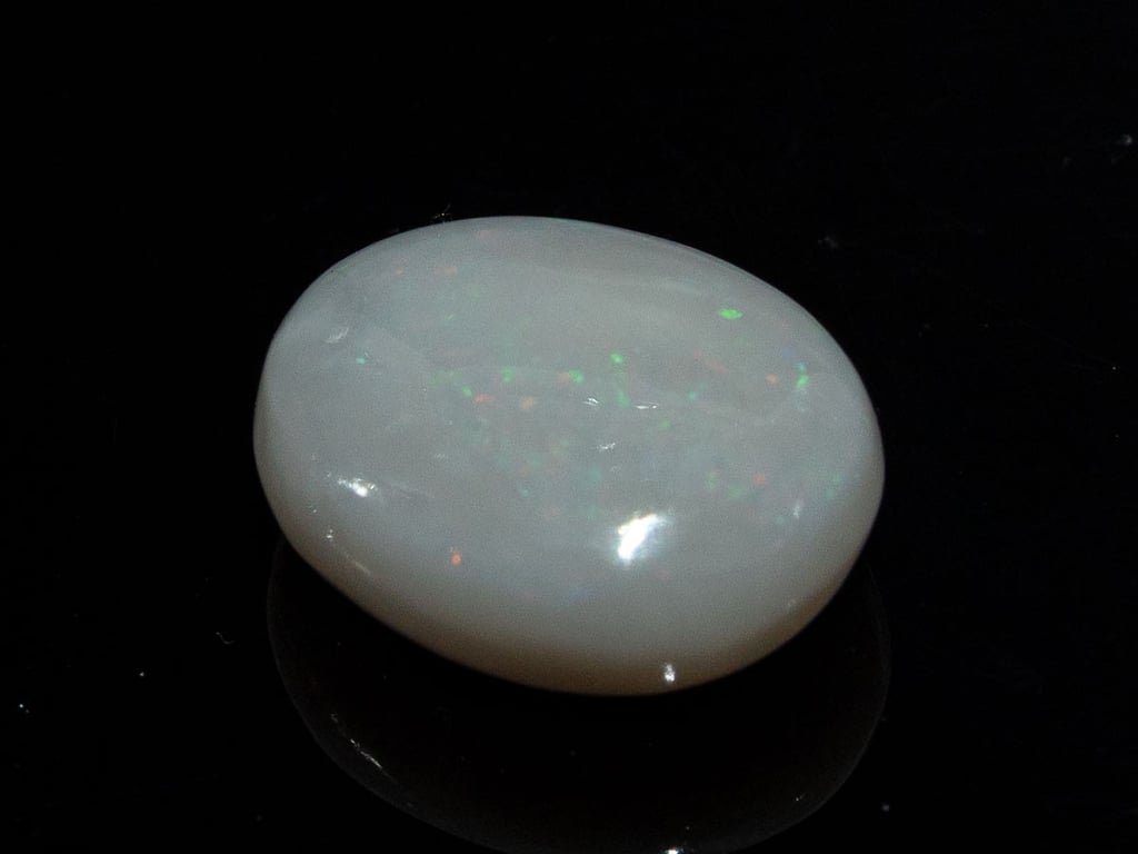 Natural Australian White Opal Stone 8.55 Carat top view: white body with small green and orange pinpoint flashes