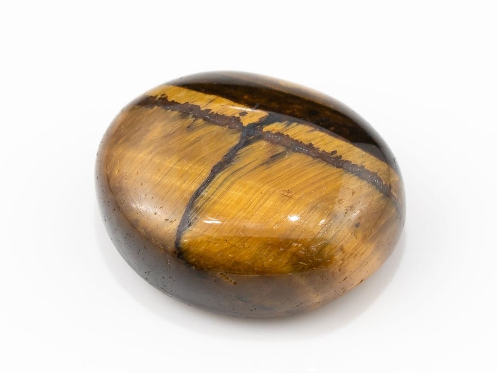 Tiger Eye Stone (Chitti) 10.78 carat, top view, golden brown oval cabochon with its band of light