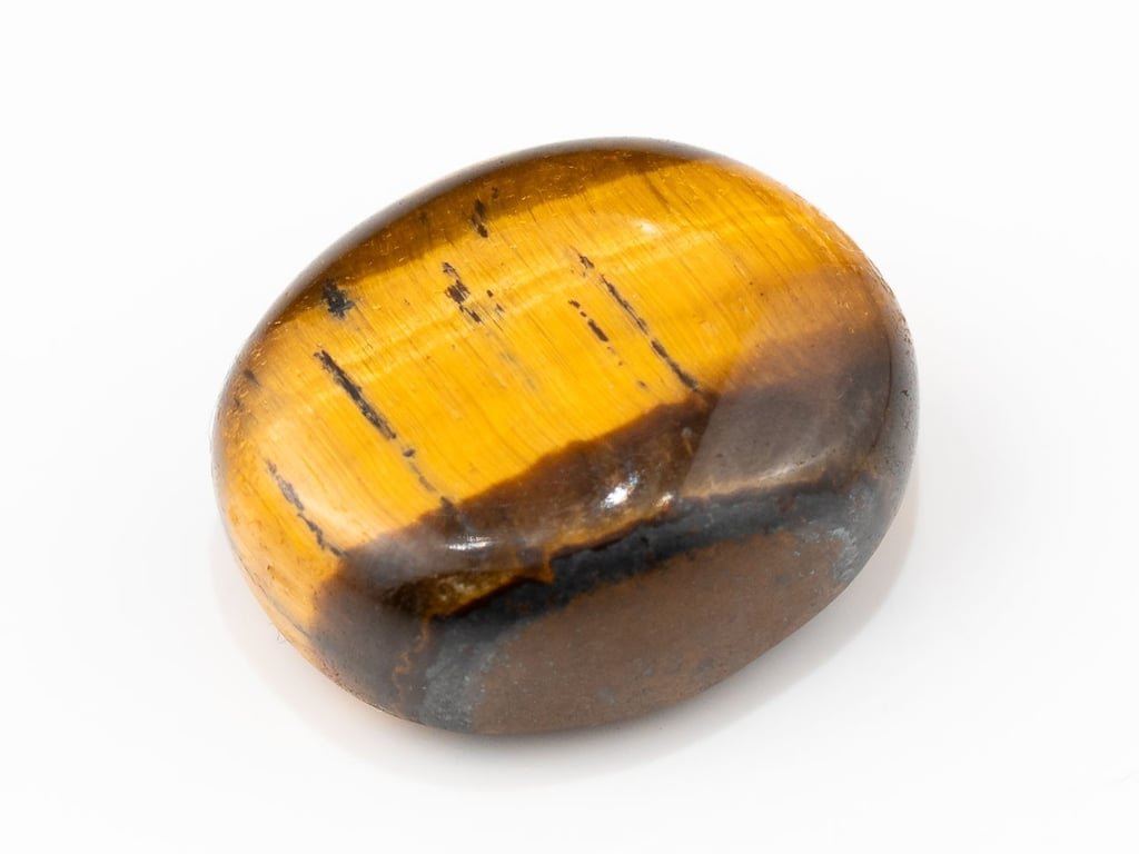 Tiger Eye Stone (Chitti) 11.40 carat, top view, golden brown oval cabochon with its band of light