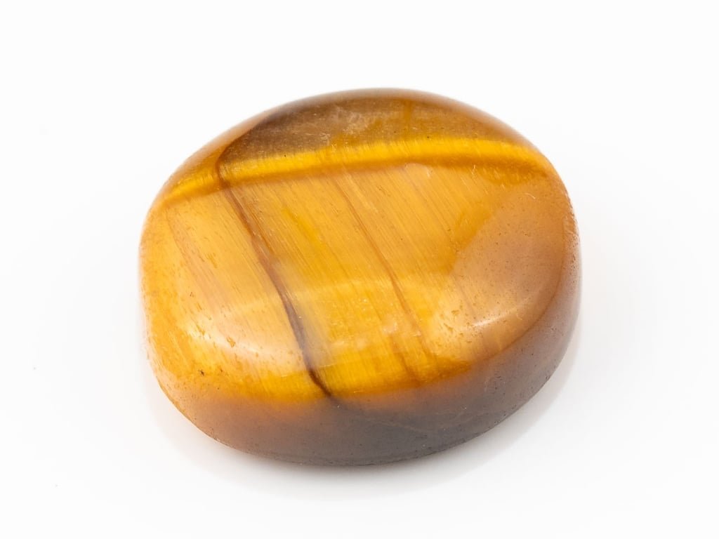 Tiger Eye Stone (Chitti) 11.50 carat, top view, golden brown oval cabochon with its band of light