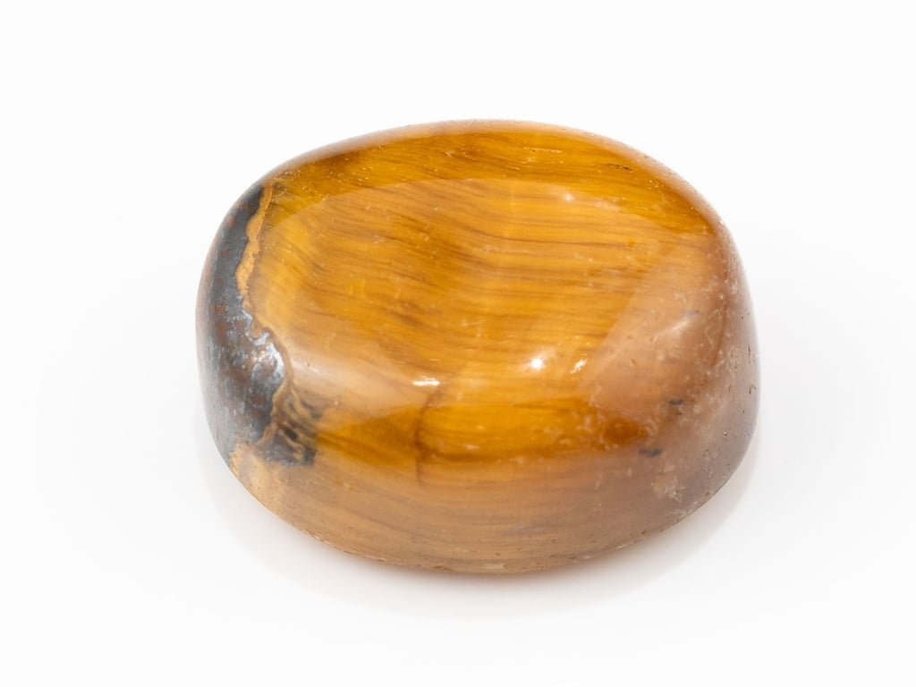 Tiger Eye Stone (Chitti) 12.40 carat, top view, golden brown oval cabochon with its band of light