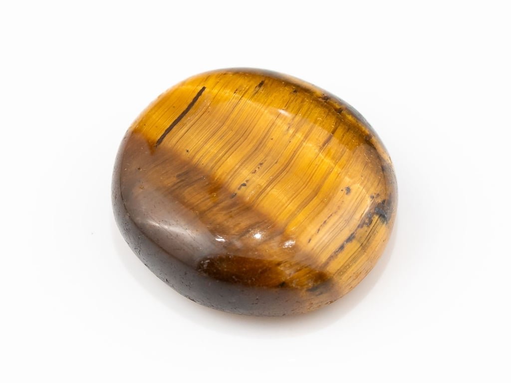Tiger Eye Stone (Chitti) 7.35 carat, top view, golden brown oval cabochon with its band of light