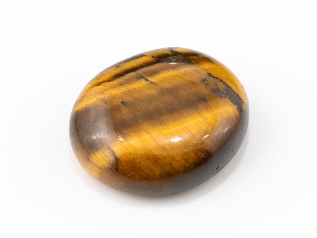 Tiger Eye Stone (Chitti) 7.54 carat, top view, golden brown oval cabochon with its band of light