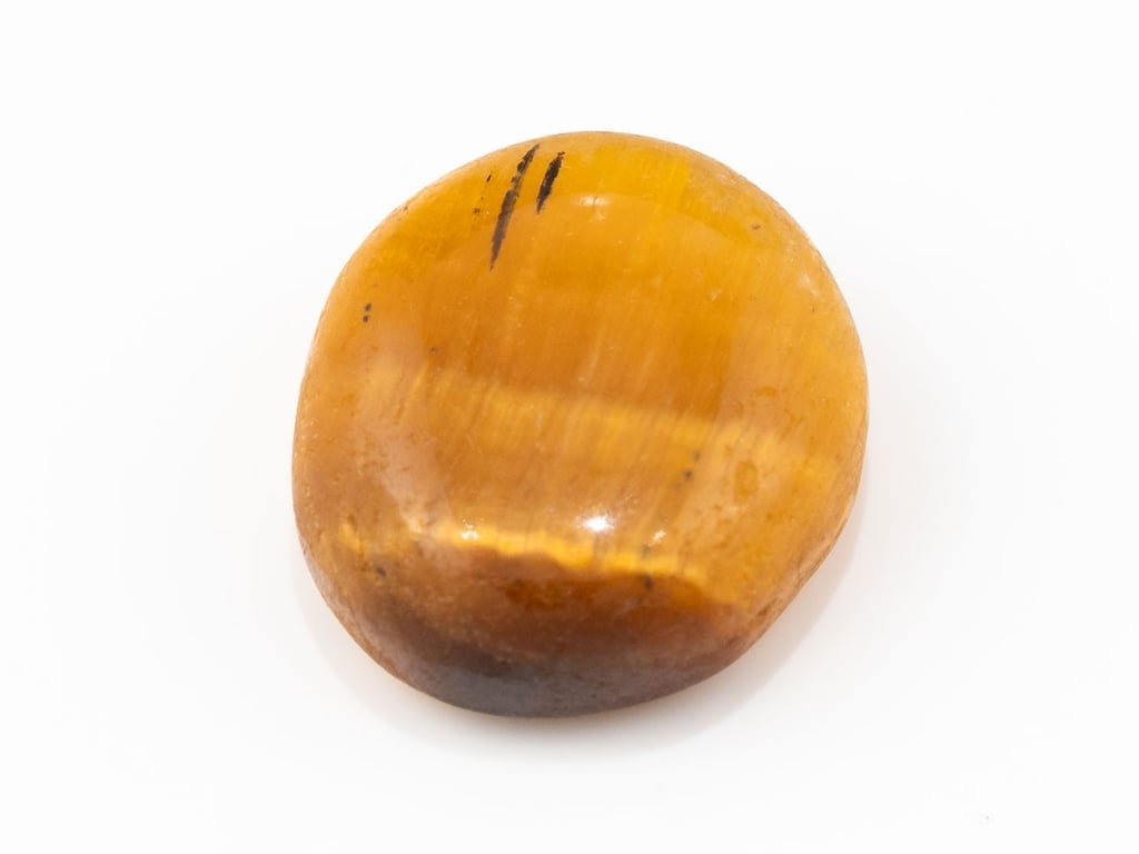 Tiger Eye Stone (Chitti) 7.72 carat, top view, golden brown oval cabochon with its band of light