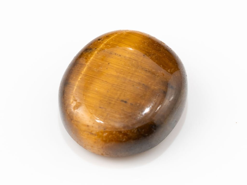 Tiger Eye Stone (Chitti) 8.06 carat, top view, golden brown oval cabochon with its band of light