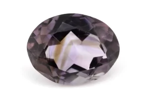 High-resolution image of the Original Amethyst Stone - 6.42 Carat (7.05 Ratti) Jamunia showcasing its vibrant blue-purple hues and flawless oval cut.