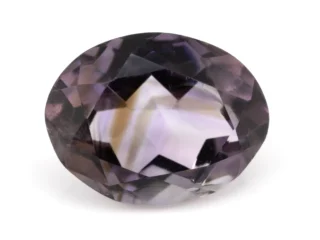 High-resolution image of the Original Amethyst Stone - 6.42 Carat (7.05 Ratti) Jamunia showcasing its vibrant blue-purple hues and flawless oval cut.