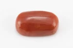 Moonga Stone 7.03 Ratti - Red Coral Stone showcasing vibrant red color and oval-round cut