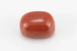 Moonga Stone 7.54 Ratti - Red Coral Stone showcasing vibrant red color and oval-capsule cut