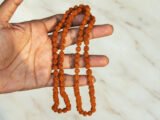 Natural Rudraksha Mala beads close-up showing clear Mukhi lines and texture