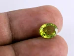 Natural Peridot Stone 3.28 Carat - in palm