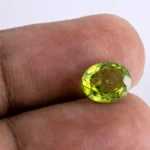 Natural Peridot Stone 3.28 Carat - in palm