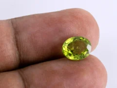 Natural Peridot Stone 3.28 Carat - in palm