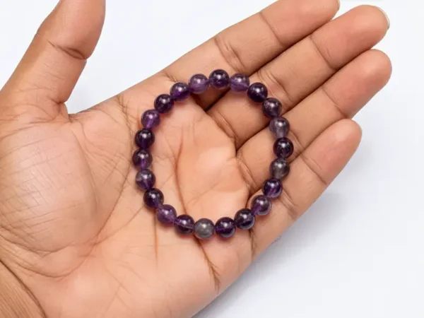 amethyst bracelet held in palm for size reference