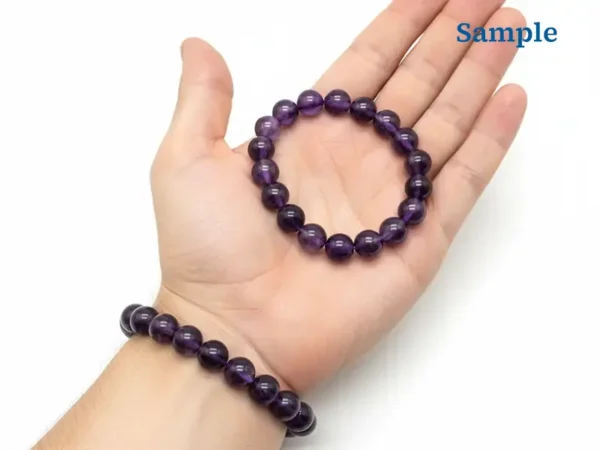 amethyst bracelet held in palm for size reference