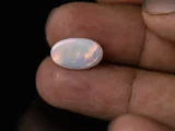 Holding a certified 3.50 Carat (3.85 Ratti) Australian Fire Opal
