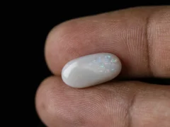 Holding a certified 3.78 Carat (4.15 Ratti) Australian Fire Opal