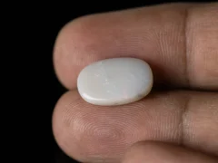 Holding a certified 4.31 Carat (4.74 Ratti) Australian Fire Opal