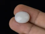 Holding a certified 8.05 Carat (8.85 Ratti) Australian Fire Opal
