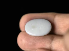 Holding a certified 8.56 Carat (9.41 Ratti) Australian Fire Opal