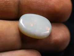 Holding a certified 8.87 Carat (9.75 Ratti) Australian Fire Opal