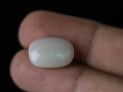 Holding a certified 9.46 Carat (10.39 Ratti) Australian Fire Opal