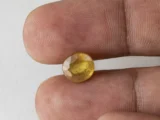 Holding a certified 4.40 ratti pukhraj stone from Ratna Gems