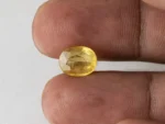 Holding a certified 4.46 ratti pukhraj stone from Ratna Gems