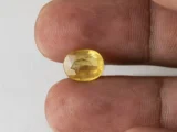 Holding a certified 4.46 ratti pukhraj stone from Ratna Gems