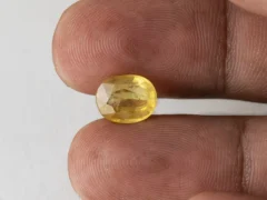 Holding a certified 4.46 ratti pukhraj stone from Ratna Gems