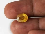 Holding a certified 5.08 ratti pukhraj stone from Ratna Gems