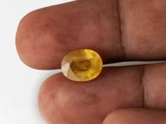 Holding a certified 5.08 ratti pukhraj stone from Ratna Gems