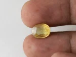 Holding a certified original pukhraj stone from Ratna Gems