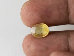 Holding a certified original pukhraj stone from Ratna Gems