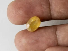 Holding a certified original pukhraj stone from Ratna Gems