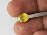 Holding a certified 5.40 ratti pukhraj stone from Ratna Gems