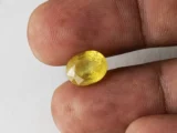 Holding a certified 5.40 ratti pukhraj stone from Ratna Gems